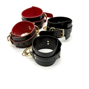 Side view of RUMAEL leather look cuffs and gold chain